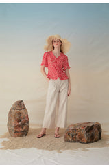 Short-Sleeve Linen Blouse With Ruffled Hem And Button-Front V-Neck Silhouette