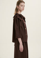 Elegant Ruffle-Collar Linen Blouse With Statement Buttons And Relaxed Tailored Silhouette