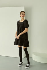 Tiered linen mini dress with square neckline and puff sleeves for effortless elegance