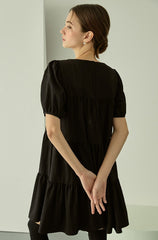 Tiered linen mini dress with square neckline and puff sleeves for effortless elegance