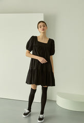 Tiered linen mini dress with square neckline and puff sleeves for effortless elegance