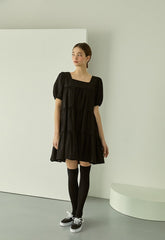 Tiered linen mini dress with square neckline and puff sleeves for effortless elegance