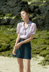 High-waisted linen mini skirt with structured silhouette and textured weave for refined summer style