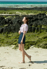 High-waisted linen mini skirt with structured silhouette and textured weave for refined summer style