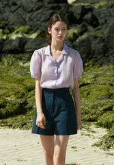 High-waisted linen mini skirt with structured silhouette and textured weave for refined summer style