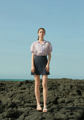 High-waisted linen mini skirt with structured silhouette and textured weave for refined summer style