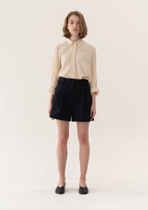 High-Waisted Tailored Linen Shorts With Adjustable Side Tabs And Minimalist Pleated Design