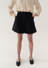 High-Waisted Tailored Linen Shorts With Adjustable Side Tabs And Minimalist Pleated Design