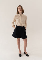 High-Waisted Tailored Linen Shorts With Adjustable Side Tabs And Minimalist Pleated Design